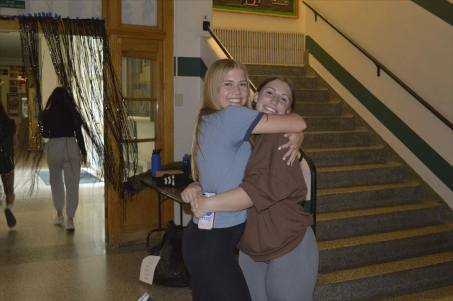 Junior Emma Bohrer and Sophomore Emirie Hastings during hall decorating 