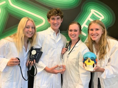 Students posing with science related items