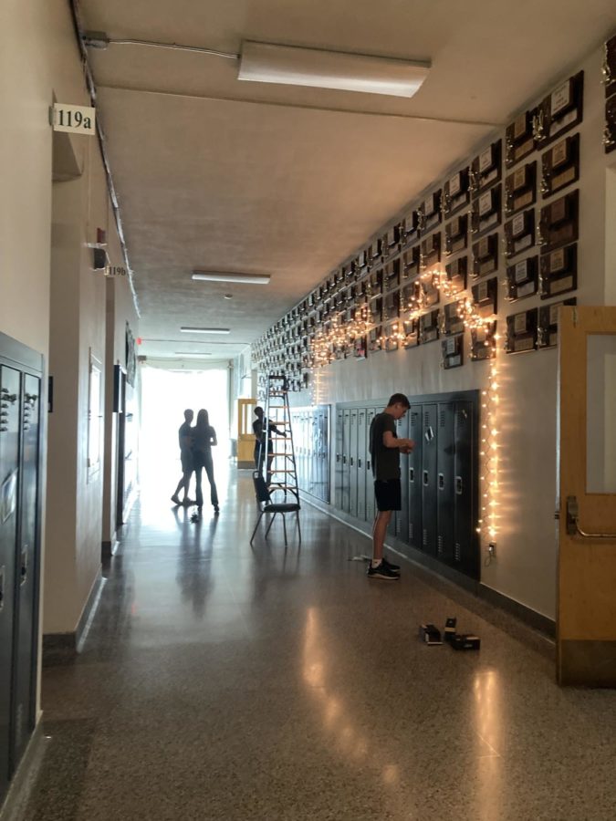 Juniors hanging lights on the wall and putting lollipops on lockers