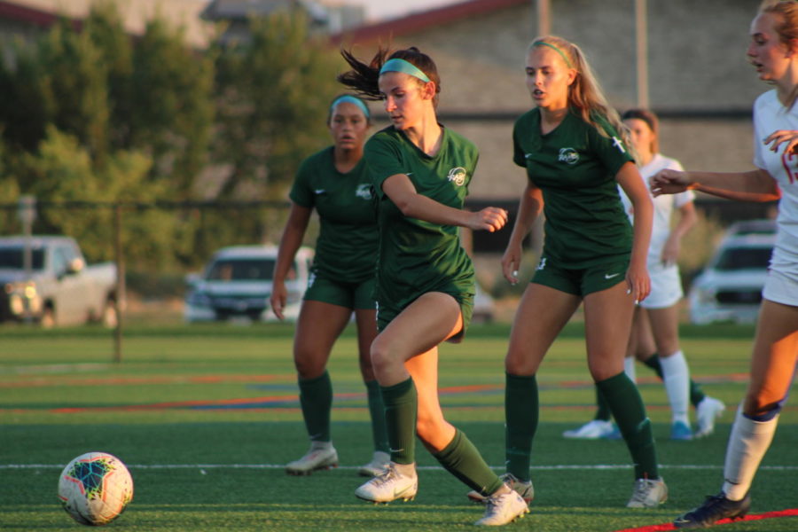 Senior Abby Derbeshire running after a stray ball during a close game