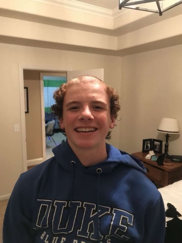 9th grader Howie Martin smiling after receiving a botched haircut.