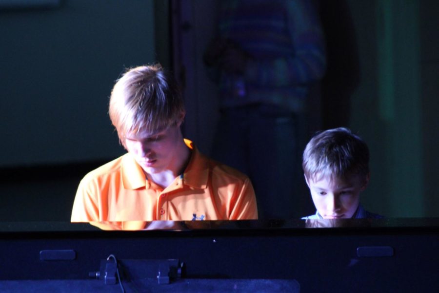 Junior Aedan Haraban and his littlest brother performing a piano duet at the Open Mic Night