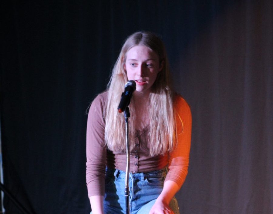 Senior Alyson Early singing at the Open Mic Night