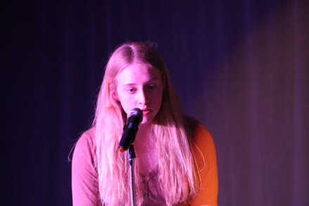 Senior Alyson Early singing at the Open Mic Night