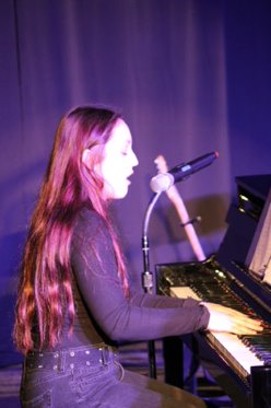 Freshman Joanne Ragsdale playing piano and singing at the Open Mic Night