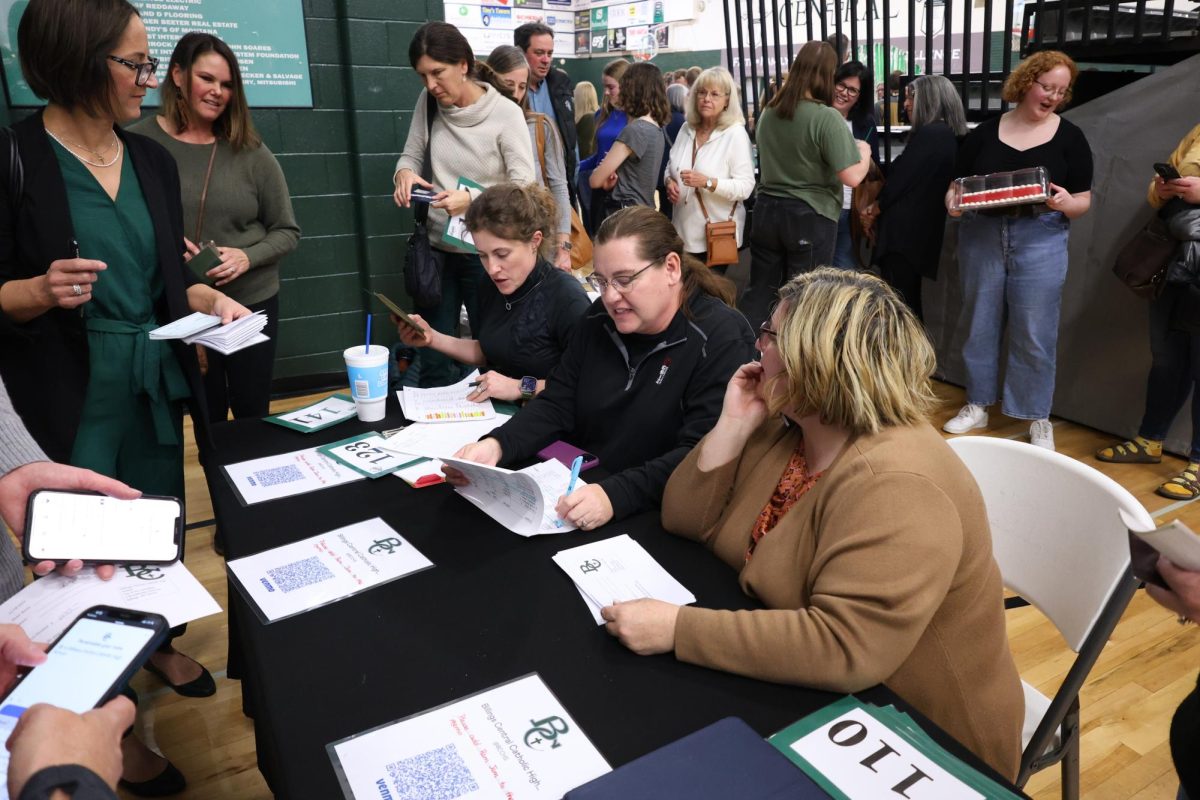 (L-R) Senior moms Jackie Owen, Mary Lague, and Jeannie Tracy helping at the Ram Jam Cake Auction on Sunday November 19, 2023. 