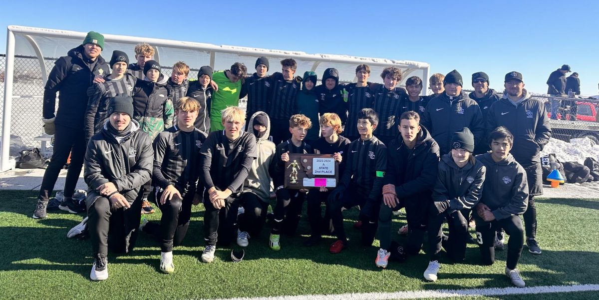 BCCHS Boys Varsity Soccer team poses with their second place trophy 