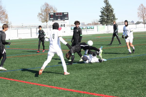 Junior Cole Bland takes a tumble over a Whitefish player 