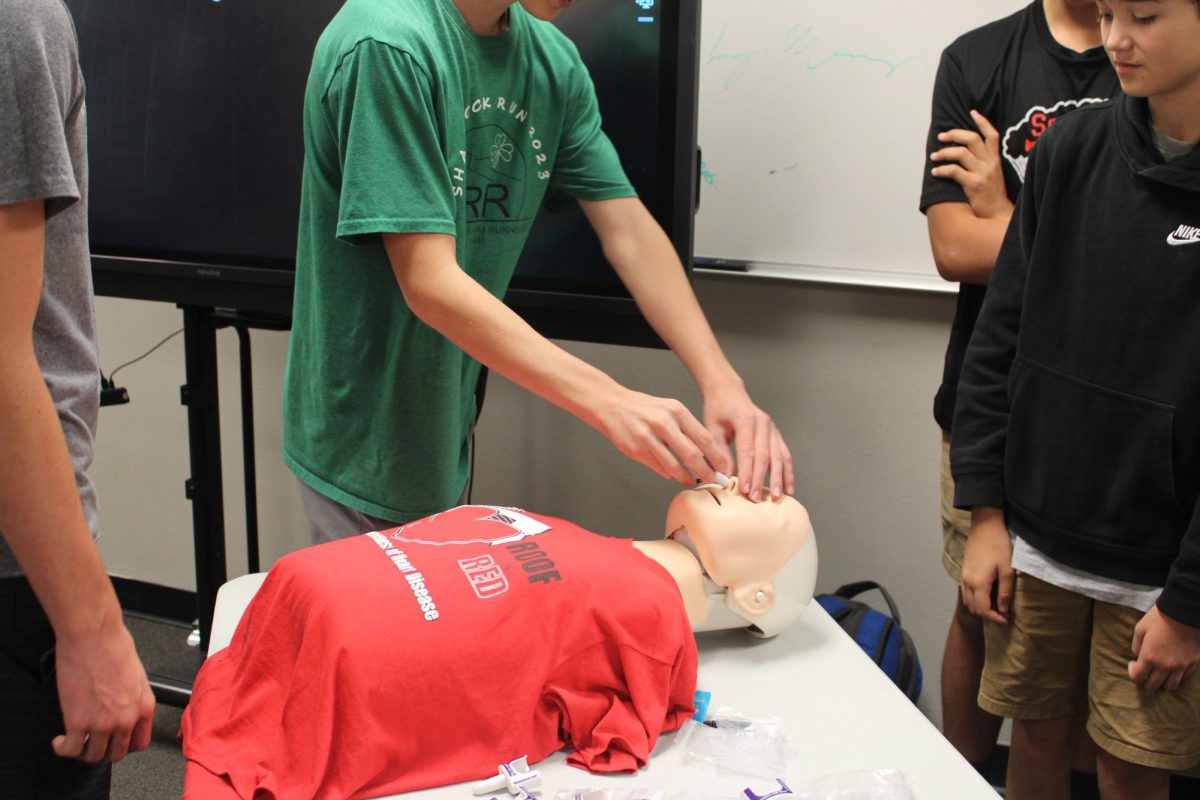 10.12.23 Sophomore students practice administering Naloxone, a drug that helps to reverse the effects of overdose, on a test dummy. 