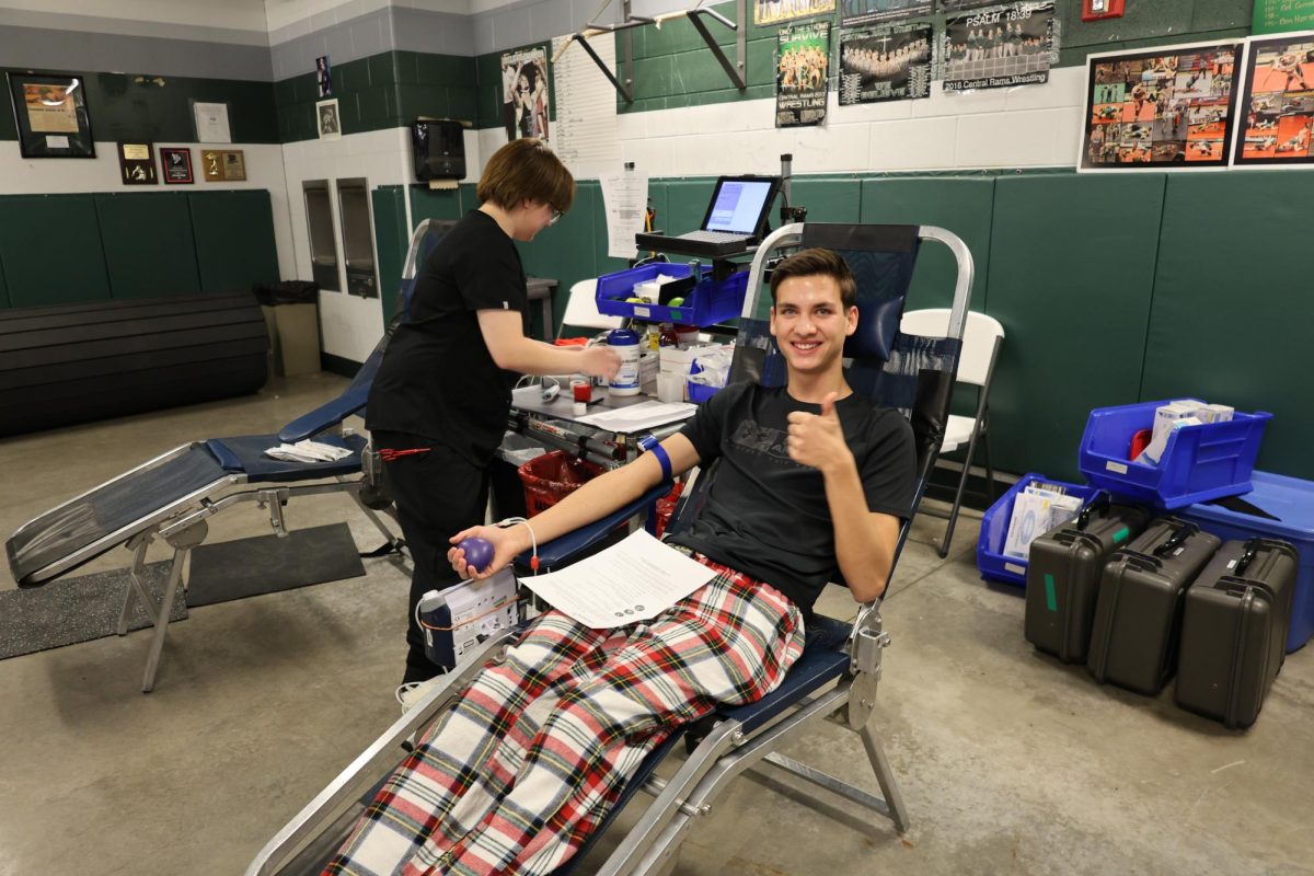 12.20.23 Junior Evan Miller gives a thumbs up while preparing to donate blood during the Stuco blood drive