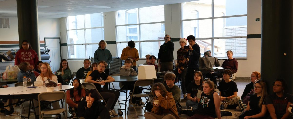 12.21.2023 Central students participating in the 24-Hour Art Challenge sit and listen to Mrs. Adams instructions for the challenge in the Central cafeteria