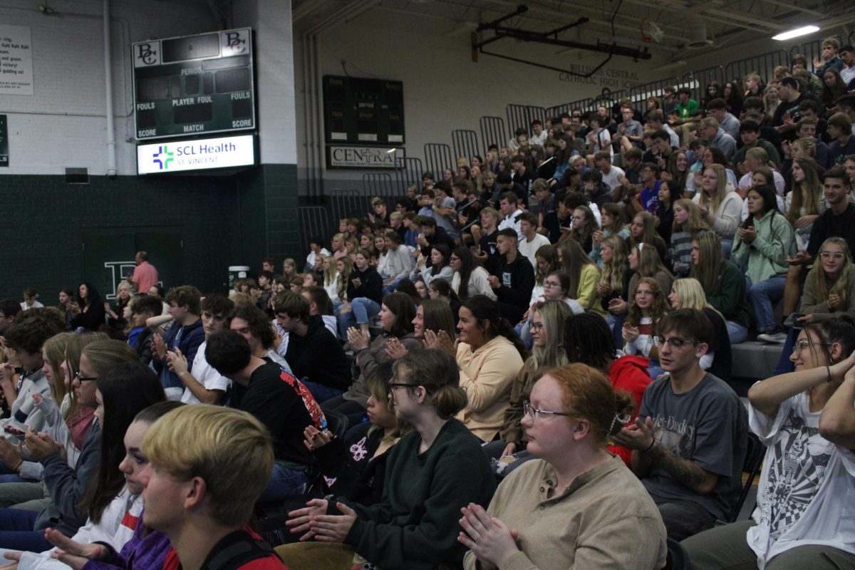 10.12.23 Students shown sitting in the bleachers watching a slideshow presented by healthcare professionals.