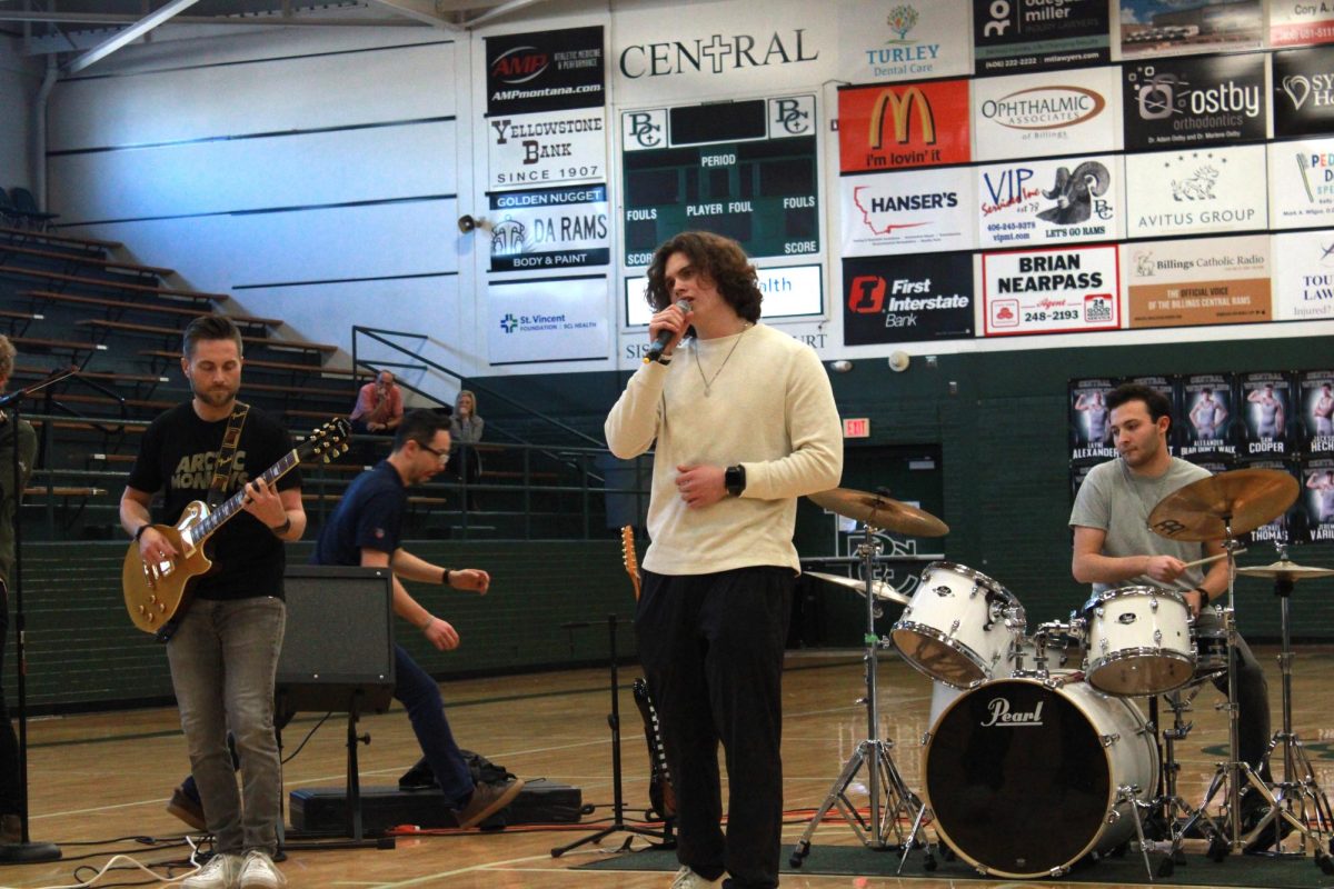 1.30.24. Senior Thomas Norman singing with senior Aidan O'Neill on drums and teacher Shane Fairbanks on guitar.