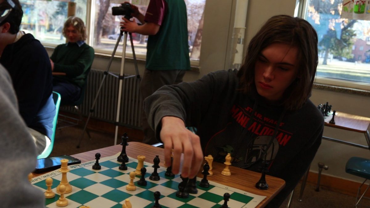 3.6.2024 Junior Montgomery Klein moving a chess piece in match.