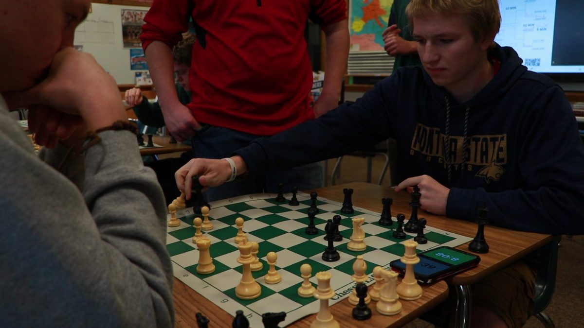 3.6.2024 Junior Luke Pankratz moving a chess piece in the tournament. 