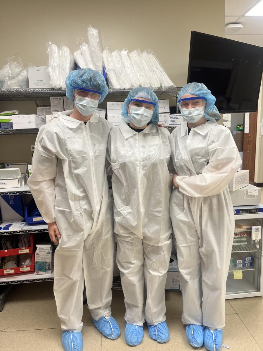 3/27/2024 From L to R, Senior, Jack Milroy, Sophomore, Ella Fairbanks, and Junior, Annie Hanser in safety gear before observing a surgery. 