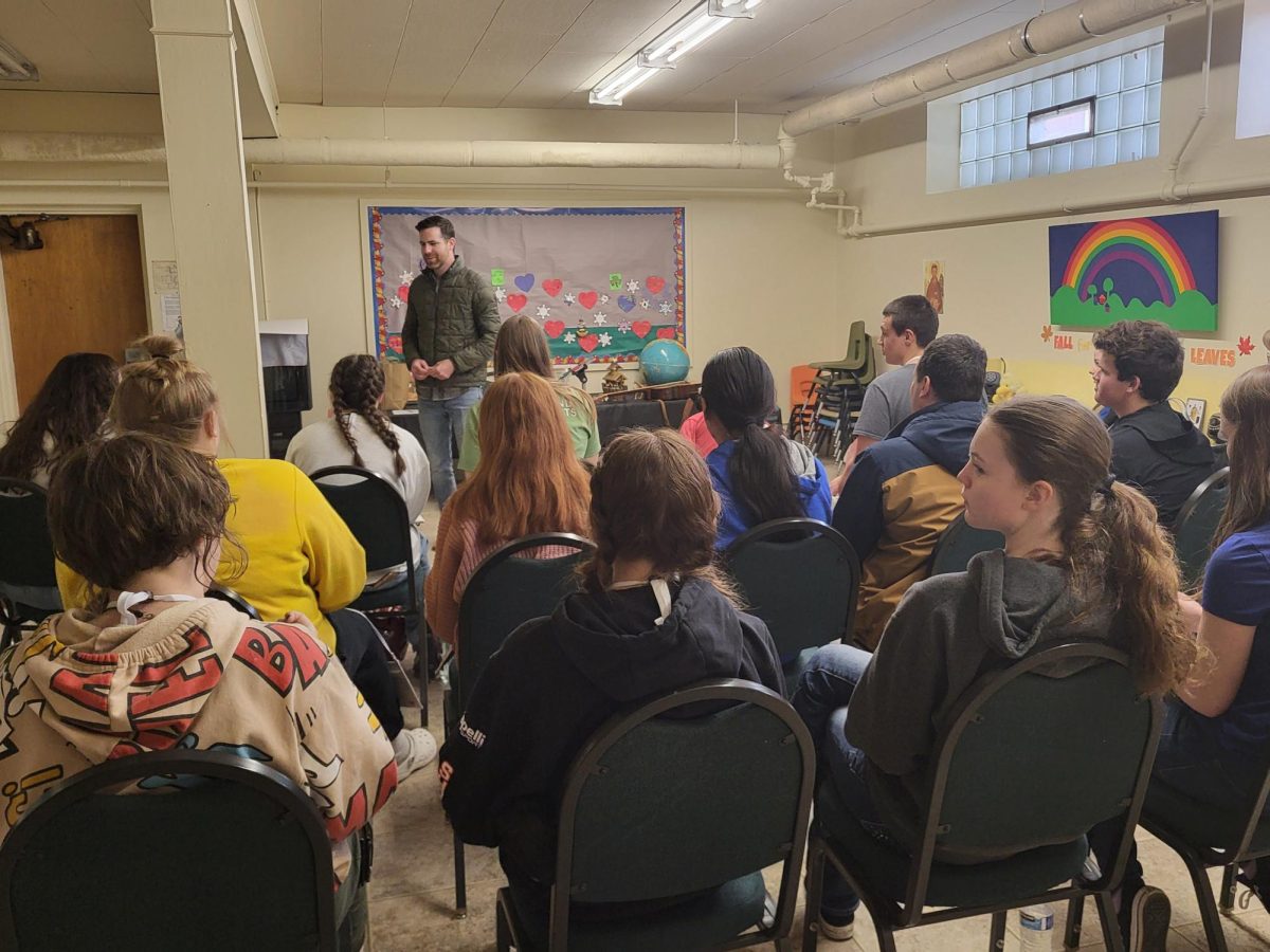 3.16.24 Keynote speaker Dan Harms speaks to a group of students about vocations and Blessed Stanley Rother during a breakout session. 