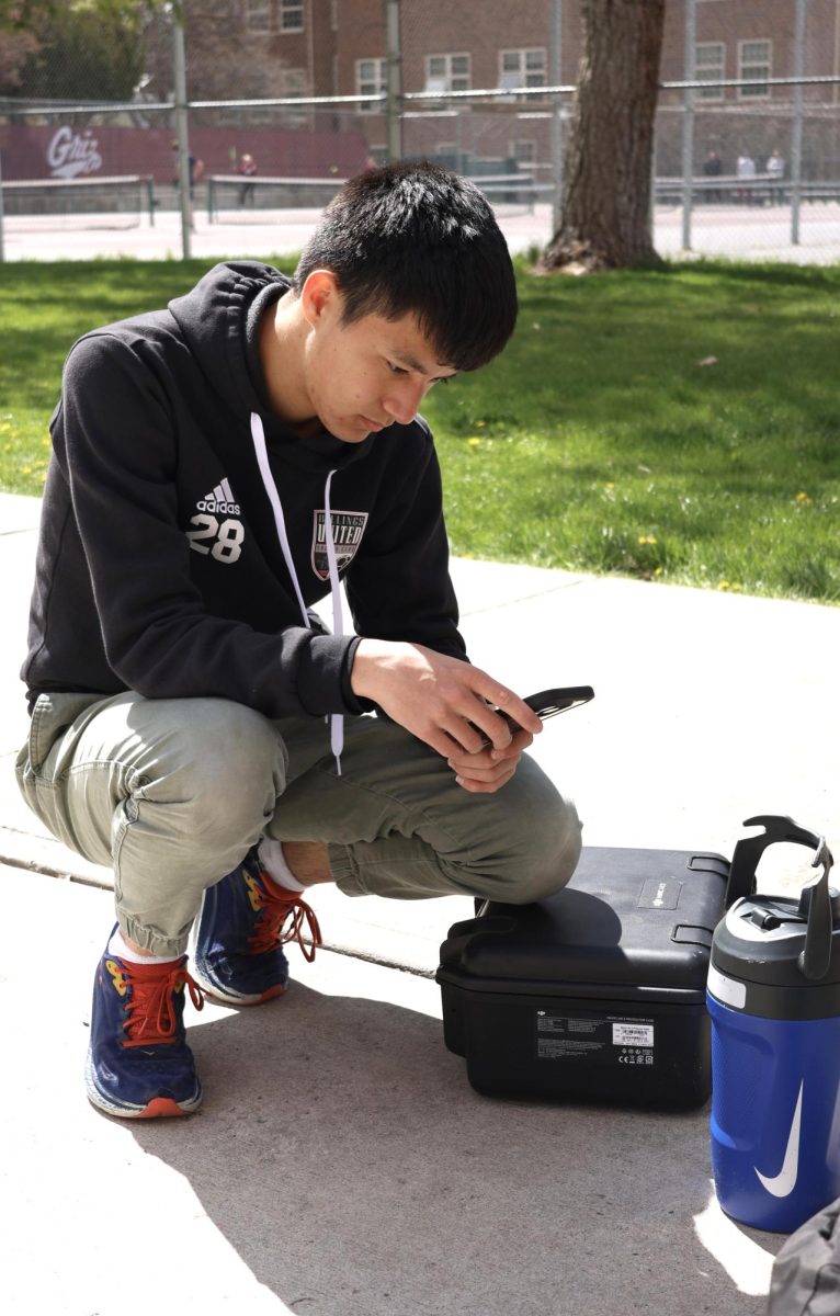 4/18/24 Senior Casey Rah setting up his drone for aerial view photos at UM. 