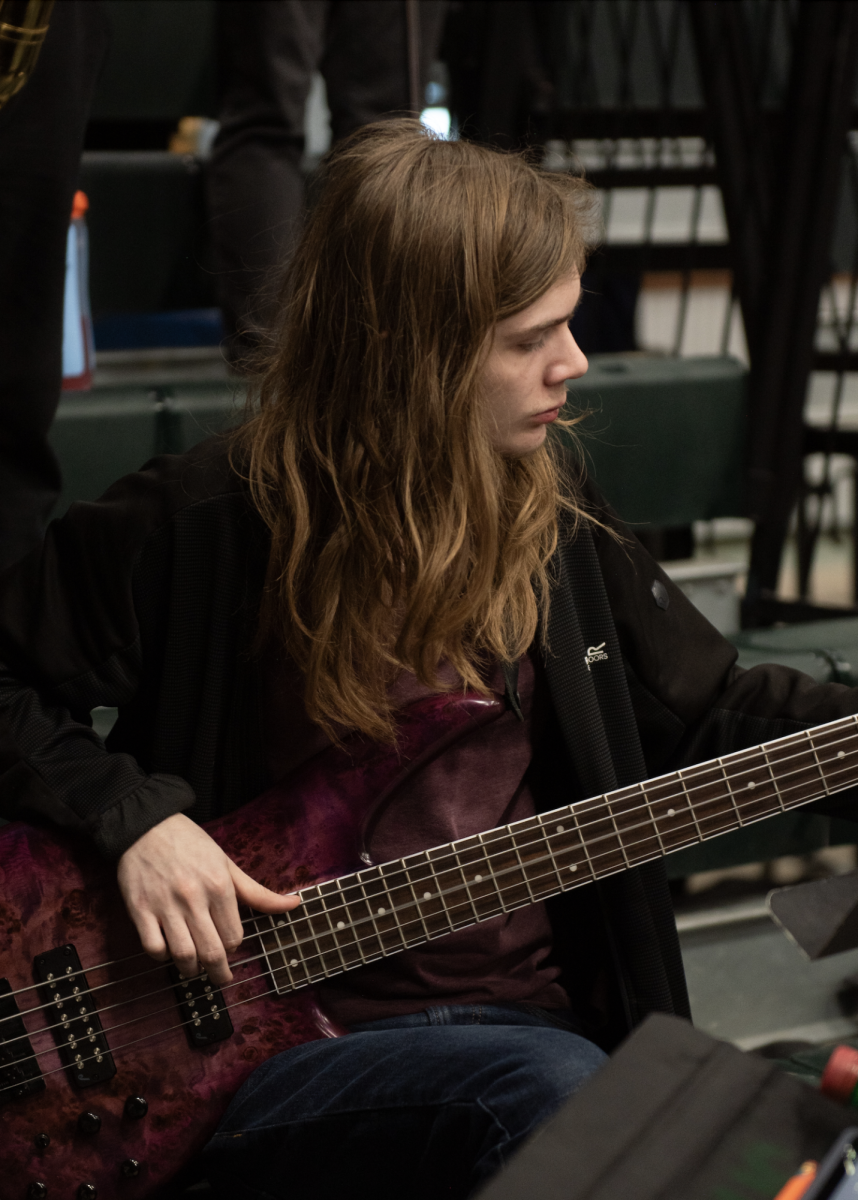 3.9.24 Senior Brayden Degel playing the bass guitar at the girls state championship basketball game in Butte.