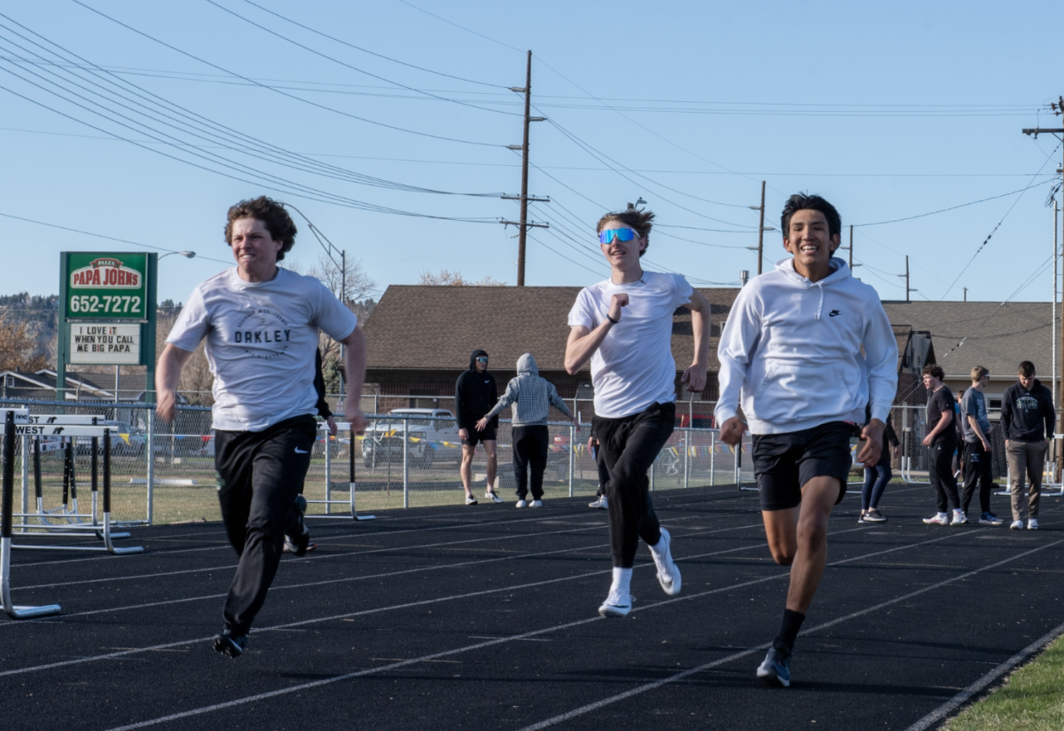 4.9.24 Sophomores racing each other in the 100m dash (L to R: Brennan Harlan, Eli Aley, Micah FallsDown).