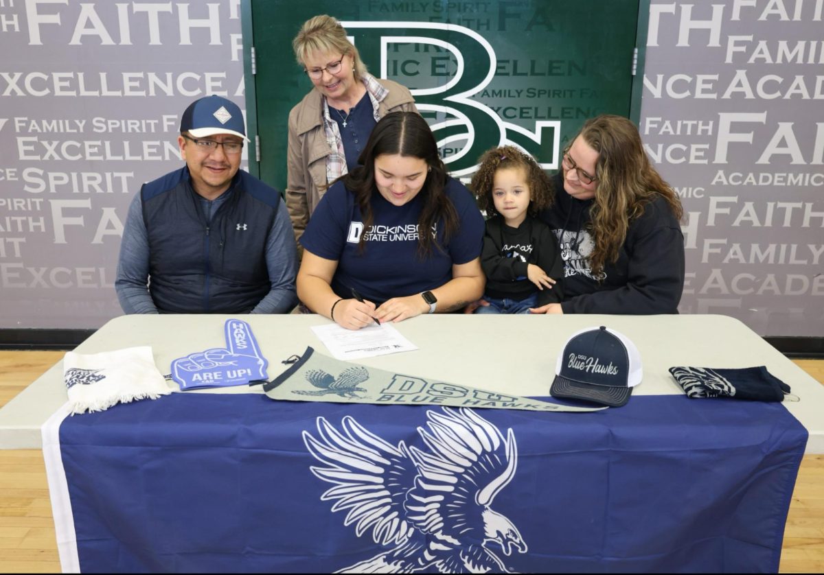 Jodi Haugen signing with her family 4.12.24