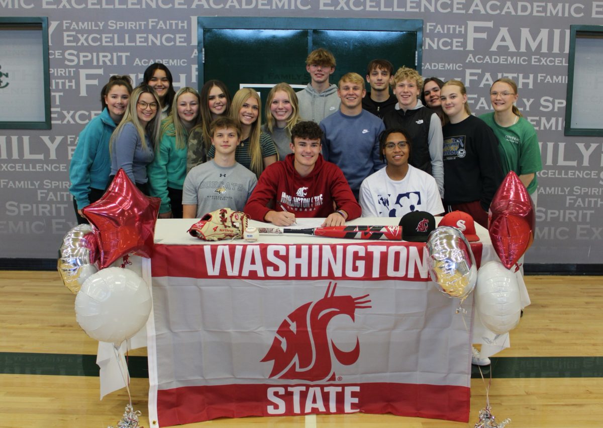 Kyler Northrop signing with while with his fellow classmates 11.8.23