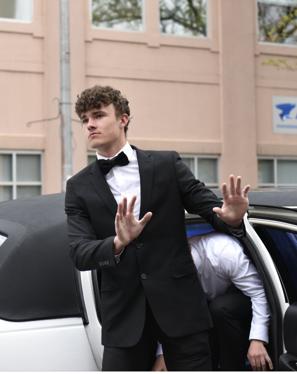 5.8.24 Senior Kyler Northrop blocks out the paparazzi as he steps out of the limo at the film premiere.