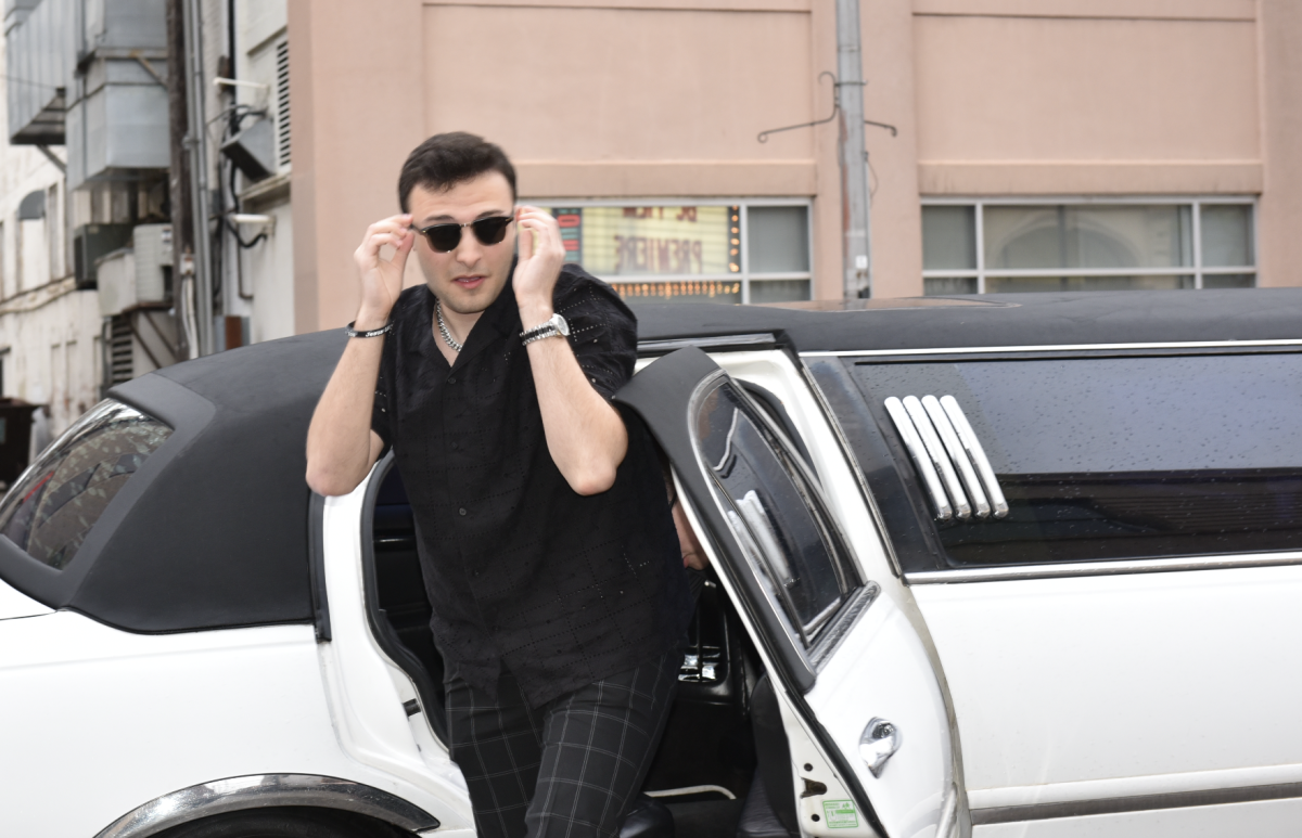 5.8.24 Senior Aidan O’Neill adjusts his sunglasses as he steps out of the limo.