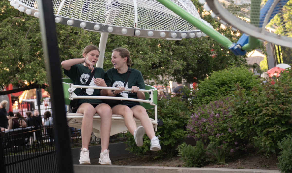 05.11.24 Freshman Paula Twichel and sophomore Olivia Guenthner riding a ferris wheel during Music in the Parks.