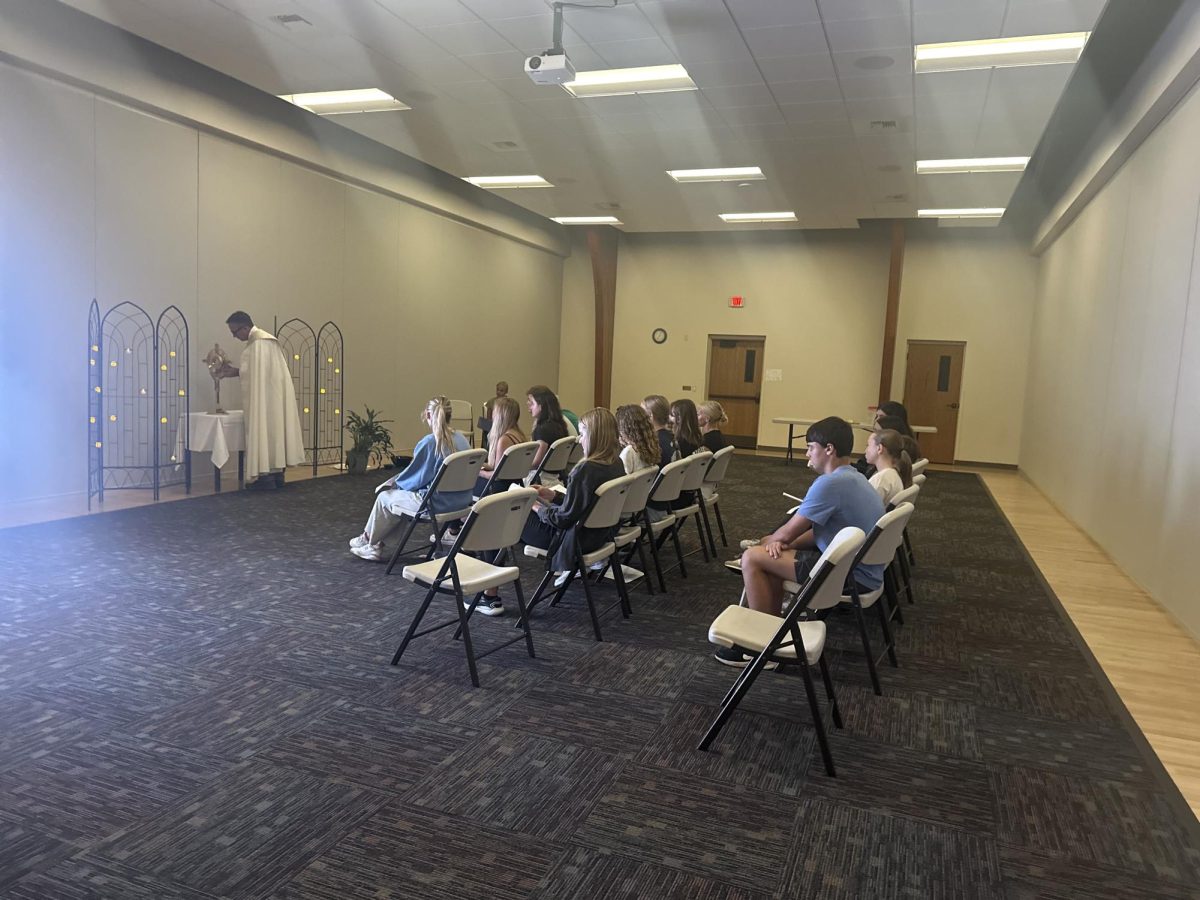 8.24.24: St. Thomas the Apostle Catholic Church youth members prayerfully sit as Deacon Nate Haney exposes the Eucharist in the monstrance.