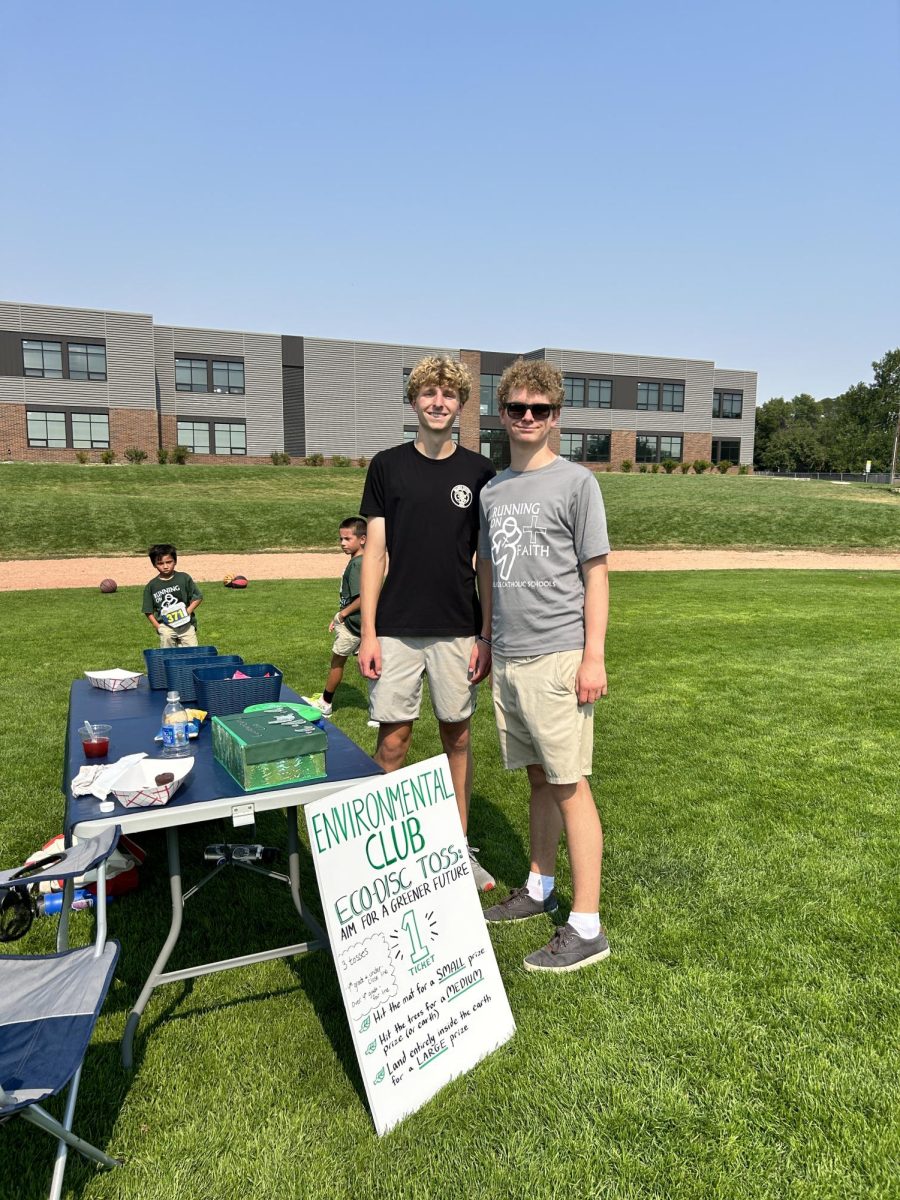 9.8.24 L to R: Juniors Bowman Seitz and Alex Johnson, promoting the environmental club at Running on Faith. 