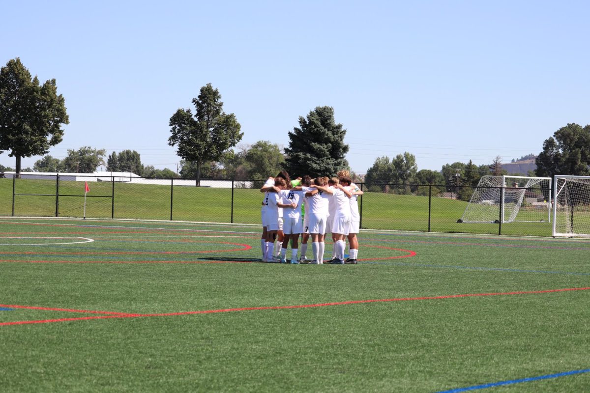 8.31.24 Boys varsity soccer huddles before their game against Whitefish.