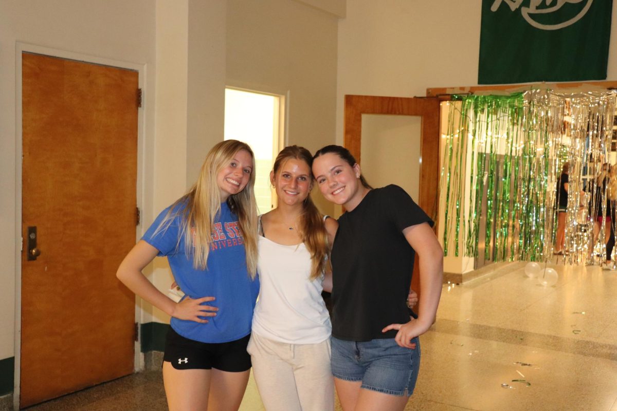 9.8.24 Juniors (L to R) Sophie Schwab, Sage Sebastian, and Danica Reas pose for a picture during the hallway decorating for homecoming.