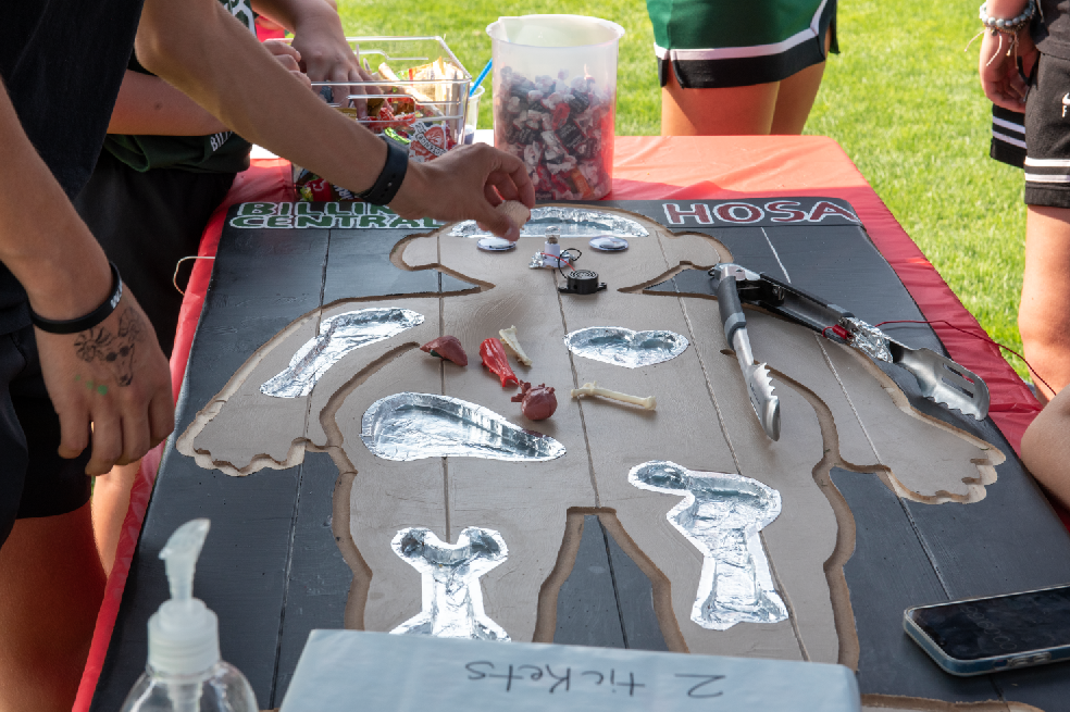 9.8.24 Organs and bones being placed into the life size operation game at HOSA’s Running on Faith booth. 