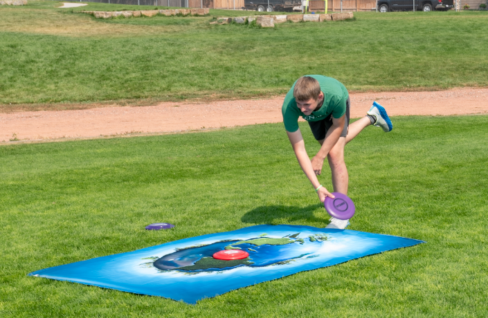 9.8.24 Junior Nathanel Keener picking up frisbees at Environmental Club’s game. 