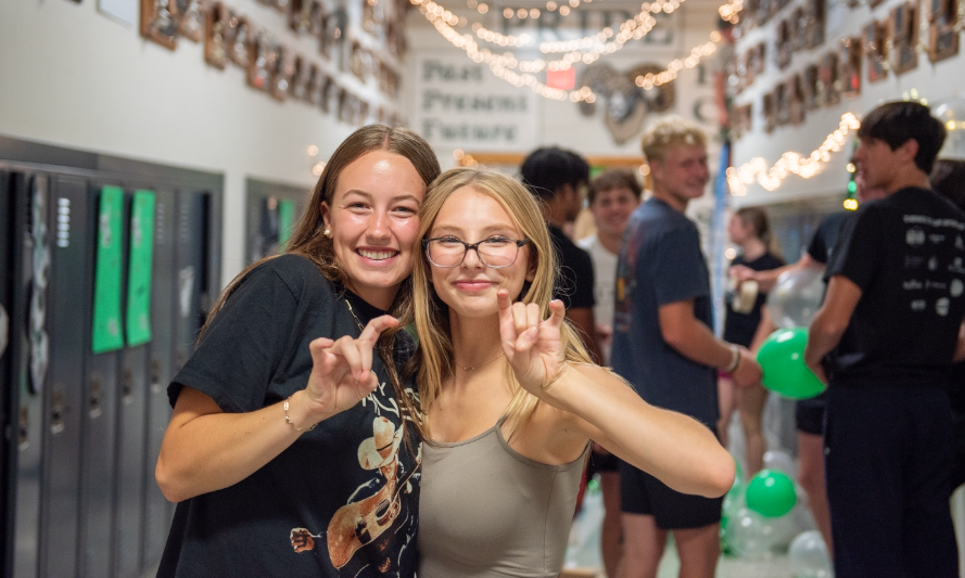 9.8.24 (From L to R) Juniors Teaghan Vaira and Brynn Sogaard pause for a quick picture before they continue decorating their hallway.