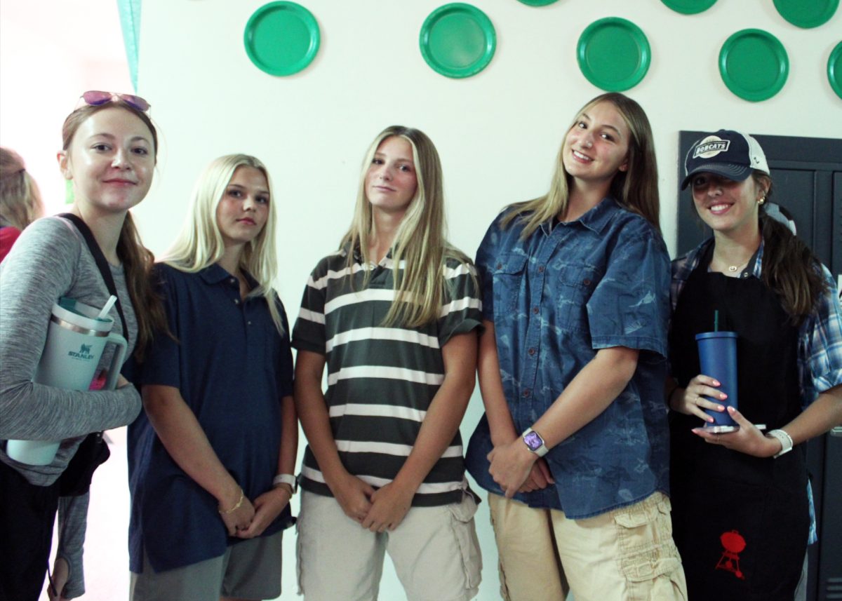 9.10.24 (From L to R) Sophomores Bellamy Harada, Avery Sorenson, Grace Jagodzinski, Kassidy Schafer, and Abbie Breetz standing in sophomore hallway on BBQ Dads vs. Soccer Moms Day. 