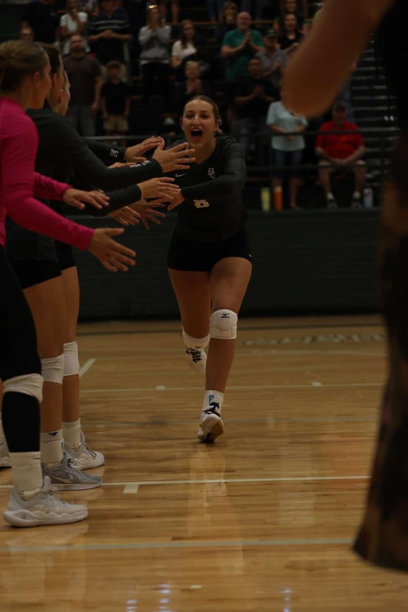 10.12.24 
Sophomore, Kassidy Schafer, gets high fives from her teammates running through the line up. 