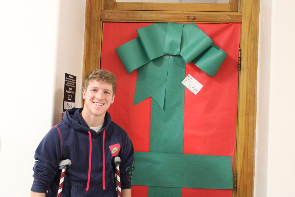 12.19.24
English teacher, Mr. Mack, in front of his Christmas-themed door