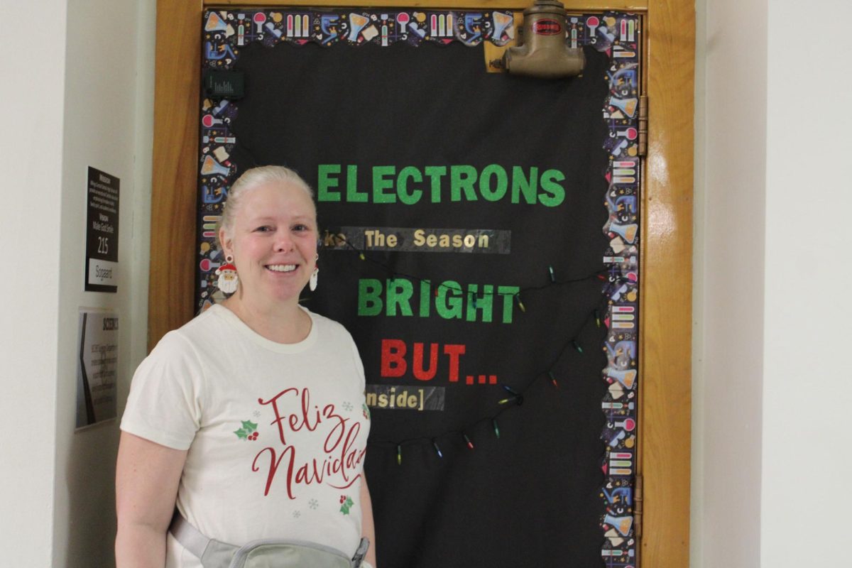 12.19.24
Mrs. Sogaard, a chemistry and biology teacher in front of her Christmas decorated door