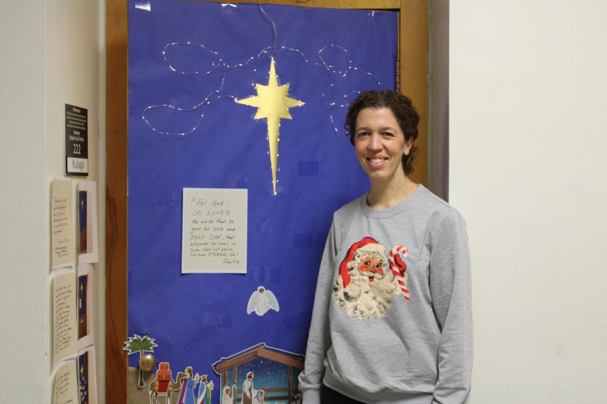 12.19.24
Mrs. Kulaga, a math teacher, in front of her Christmas-themed door