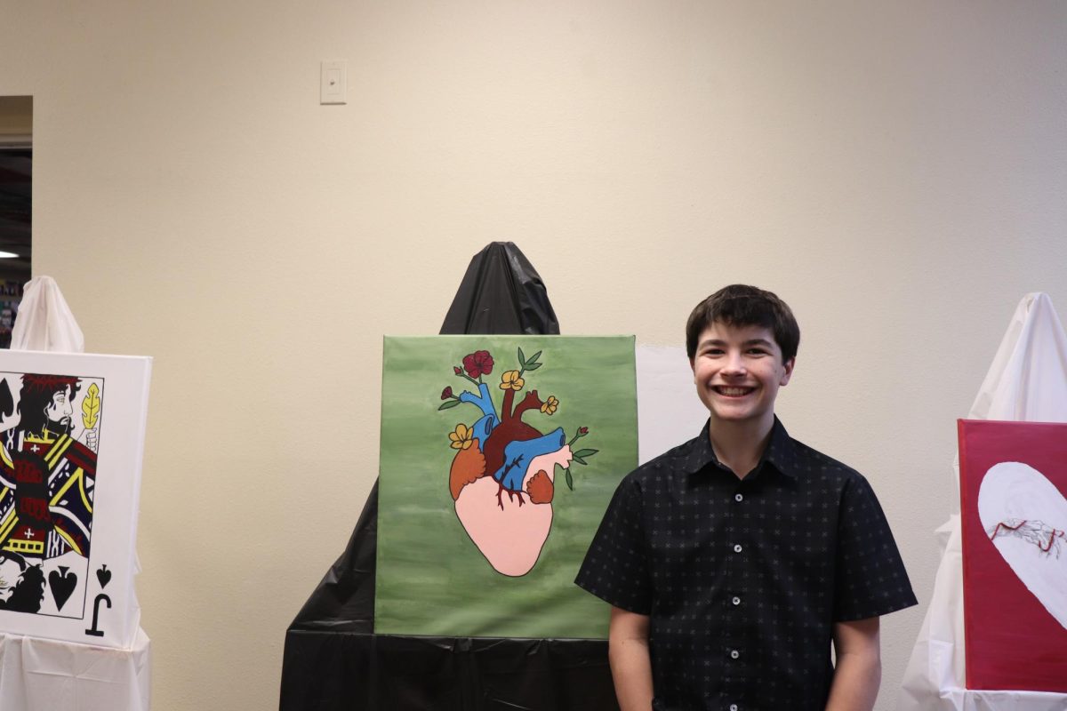 2.21.25
Freshman Preston Bernstein posing in front of his artwork during the art gala and open mic night.