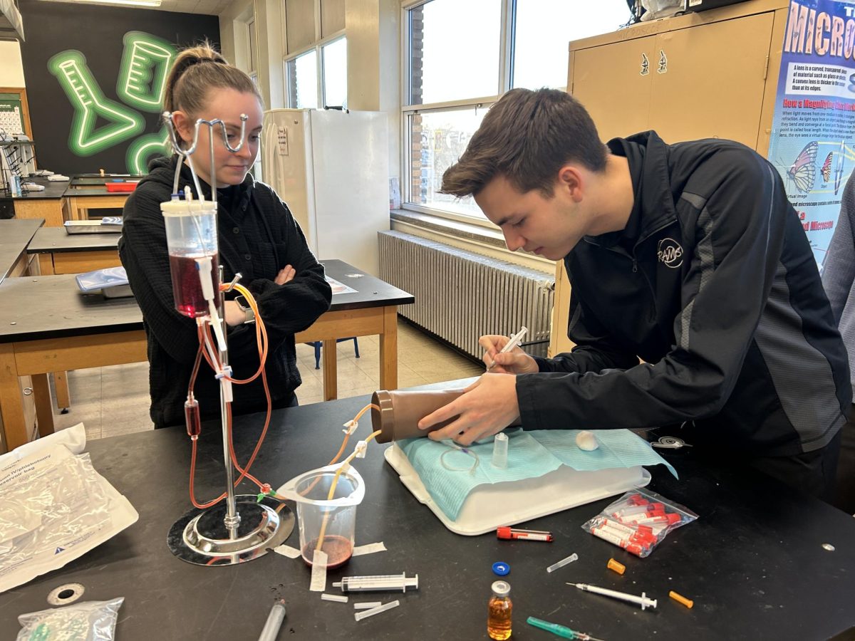 3.5.25 (From L to R) Senior Samantha Day and Evan Miller practicing injections. 