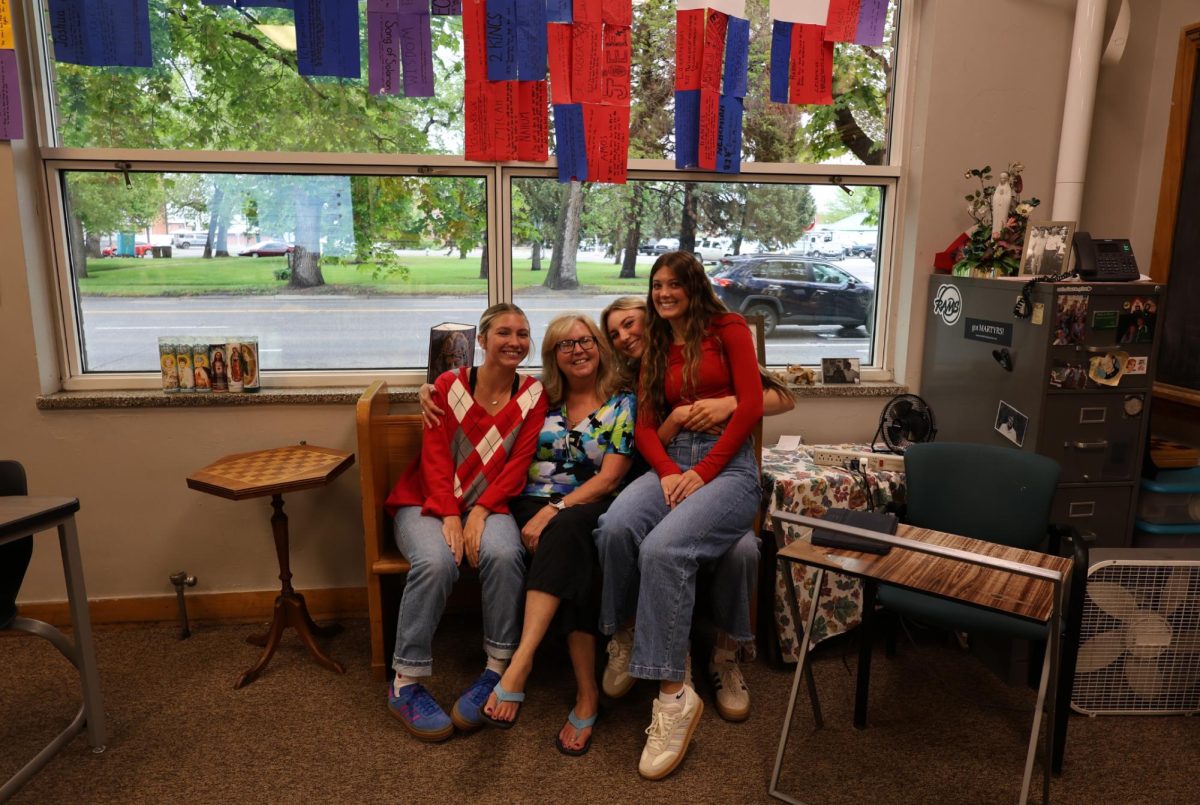 5.14.25
(L to R)
Juniors Daisy Swan, Gracie Loveridge, and Annika Stergar posing for a picture with  their theology teacher Mrs. Kelly.