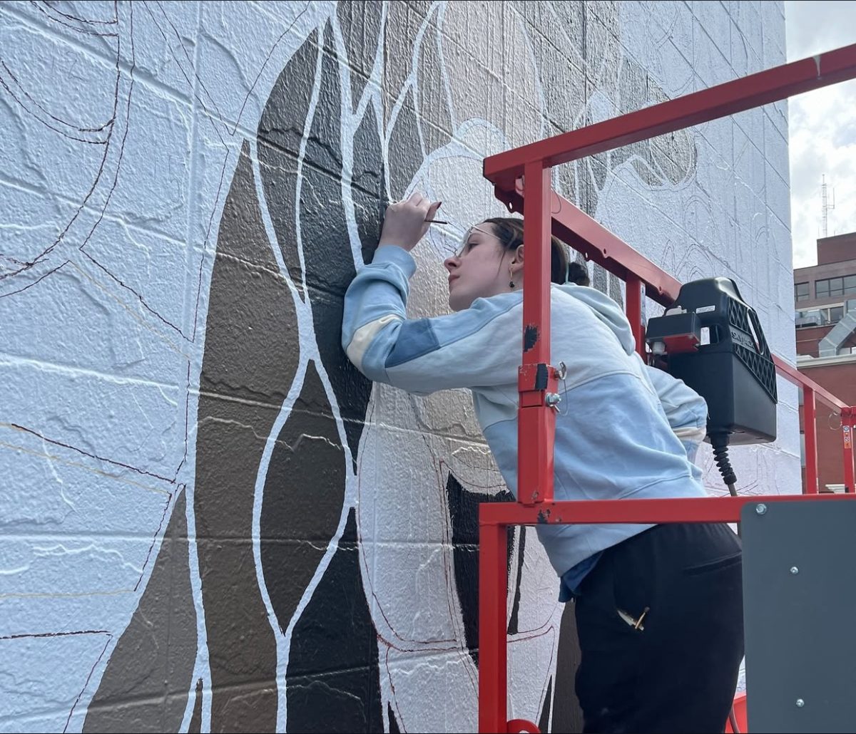 Sophomore Vivian Hastings helping with painting the mural. 