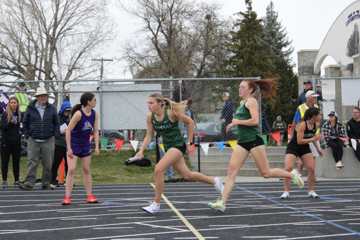 4.29.25 Junior Berkley Park passes the baton to Grace Jagodzinski. 