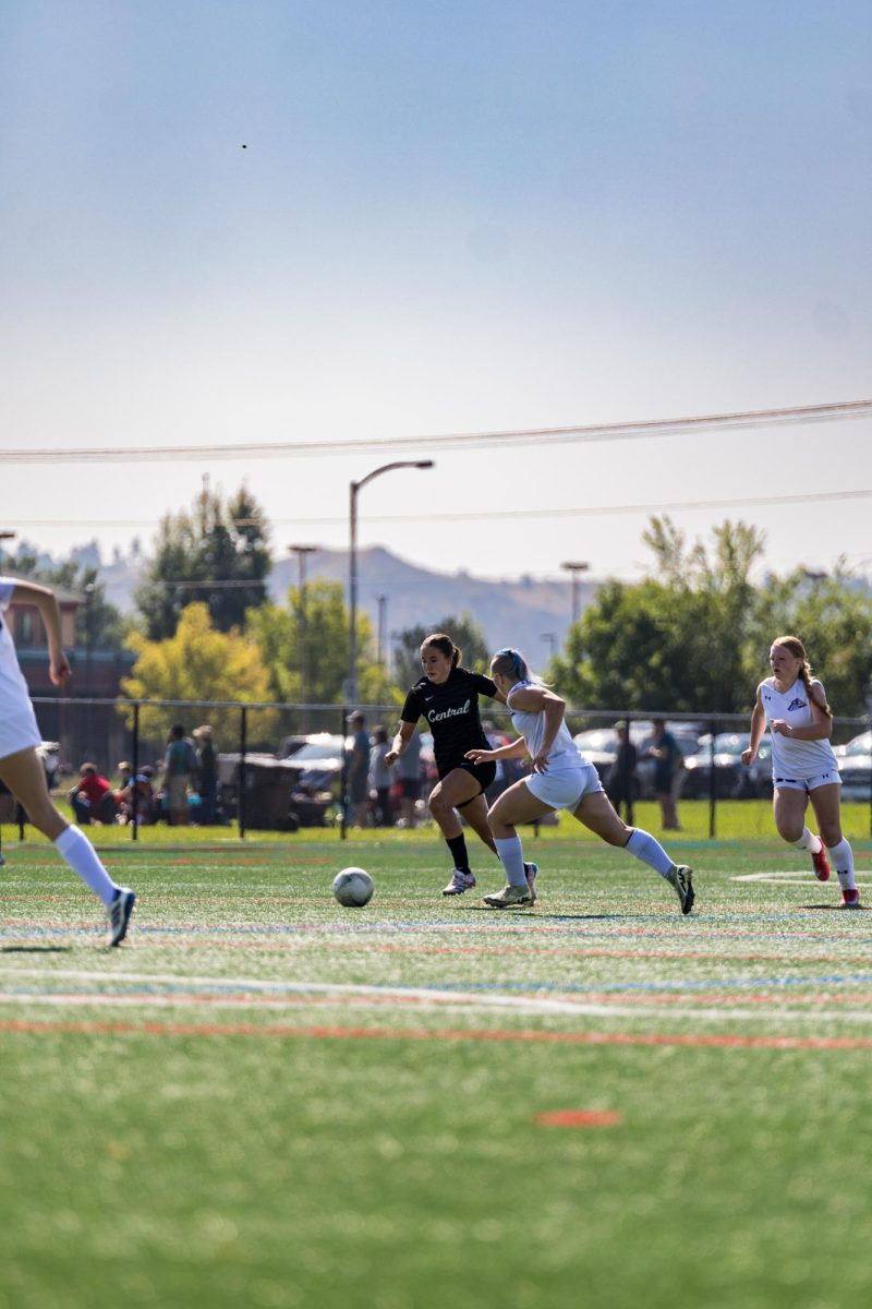9.6.25 sophomore Emerson Dull dribbling pass a Laurel Defender. 
