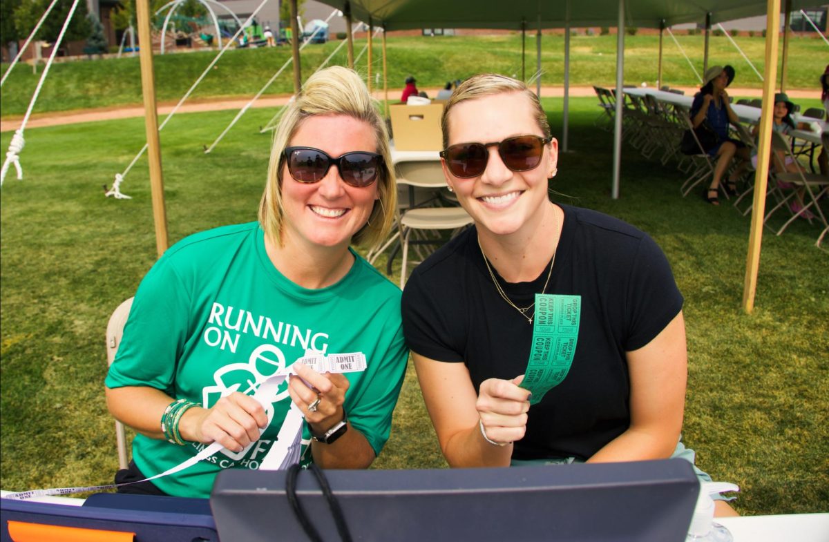 9.7.25
(From L-R) Mrs. Harris and Mrs. Hanser posing for a photo while preparing tickets for students at Running on Faith. 