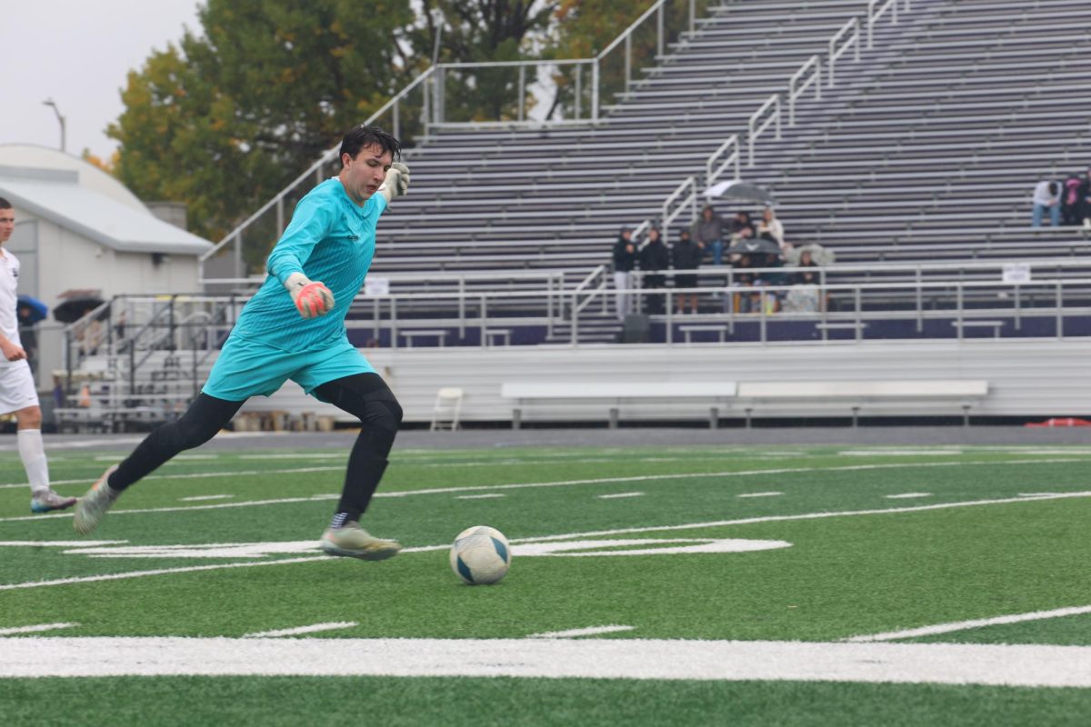 10.4.25 Senior Logan Hutzenbiler kicks the ball away from the goal. 