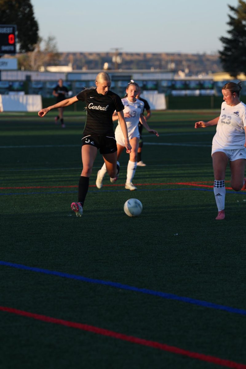9.23.25 Senior Amaya Lorash dribbles the ball around a defender in the game against Lone Peak. 